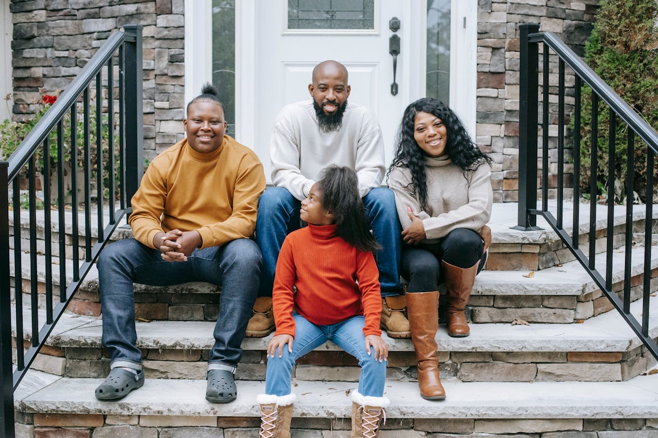 Mastering the First Impression: Your intriguing post title goes here Cheerful African American parents with son and daughter resting on stone stairs of contemporary building